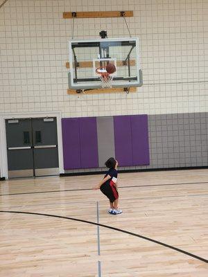 7 year old son shooting at basket which is too high