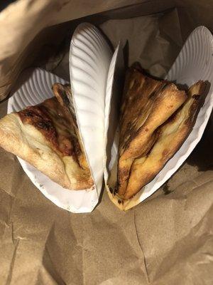 two slices folded between paper plates