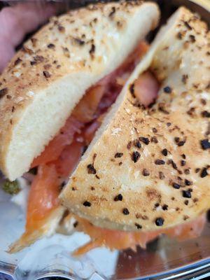 Lox and cream cheese on an onion and garlic bagel.