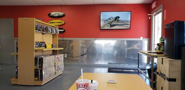 Spacious waiting area with soda, coffee, water, and a Roku!