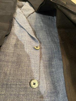 Broken  Smoke Mother of Pearl buttons on suit jacket.