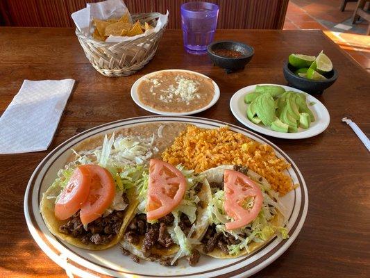 Steak taco dinner, Spanish rice, beans and avocado.