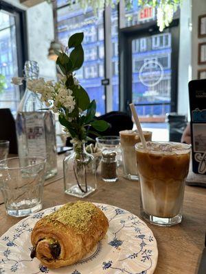 pistachio chocolate croissant and an iced latte