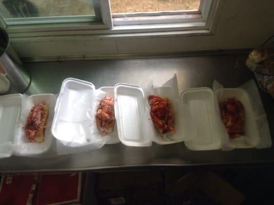 Lobstatonian lobster rolls lined up to go out for order.