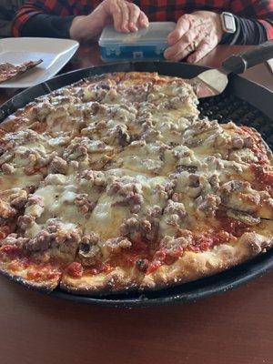 Sausage and mushroom tavern style pizza