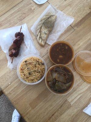 chicken on a stick, beef empanada, beans, and pepper steak.