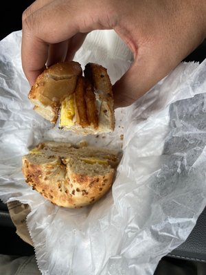 Turkey egg and cheese with black pepper on an onion bagel toasted with a hash brown on the middle