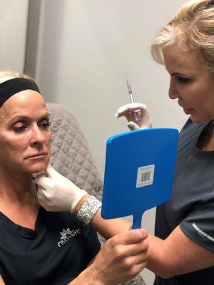 ARNP Donna treating a patient with Juvéderm cheek filler.