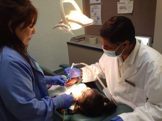 Rita and Dr. Dave working on my daughters teeth.