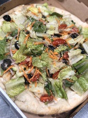 Personal salad pizza with balsamic vinaigrette.