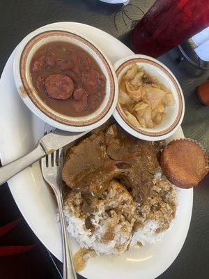 Smothered pork chop, cabbage, rice & beans, cornbread muffin