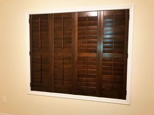 Wood stained plantation shutters.