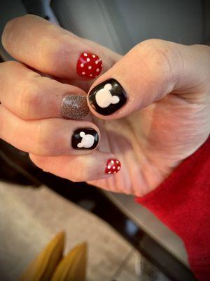 Gel nails with Disney nail art.