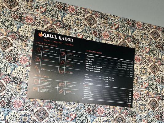 The menu is displayed on a beautiful tile wall.