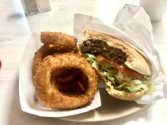 Large cheeseburger with homestyle onion rings.