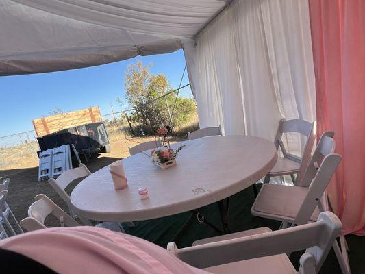 Tables and chairs left bare with no linens or plates.