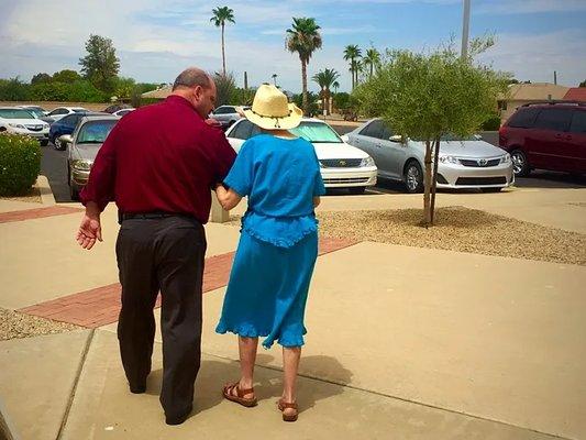 Companion Driver walking one of our Faith Riders to their car after church.