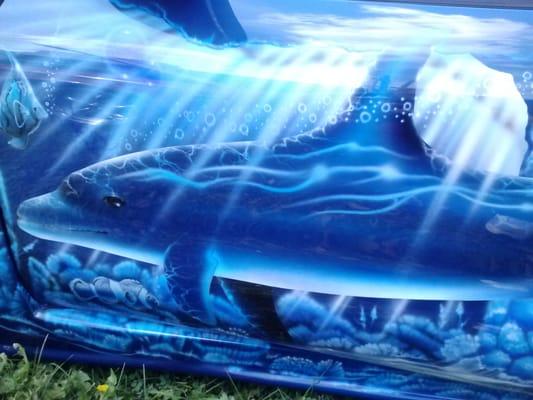 Dolphins along drivers' side of car. Beautiful work over entire car here as well.