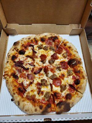 Pepperoni, sausage,  and bacon brick oven pizza.