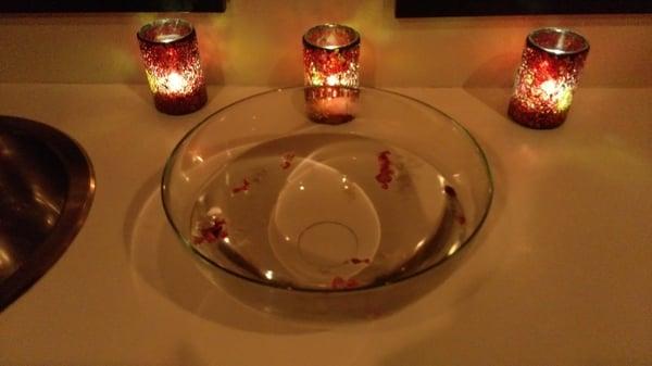 A welcome bowl of warm water and rose petals is drawn for you to rinse off your hands before your treatment starts.