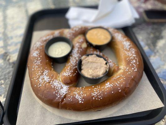 Giant pretzel with beer cheese, honey mustard and cinnamon butter sauces