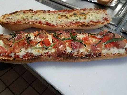 French bread pizza topped with prosciutto roasted pepper and fresh basil.