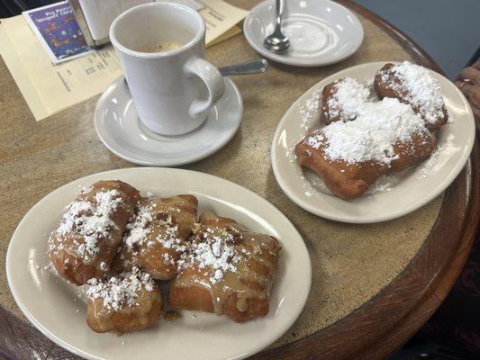 Praline glazed beignets and original powdered sugar beignets with cafe au lait! So good.