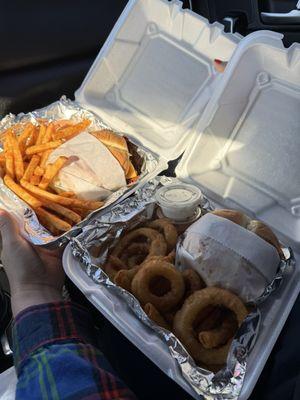 American Double Smash burgers, one with onion rings and their special sauce and the other with fries and their special sauce made in house