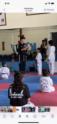 My Son receiving his Orange Belt.