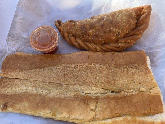 Large Cuban bread and an empanada. The latter comes with hot sauce. Cuban bread is buttery crispiness. 5 stars.