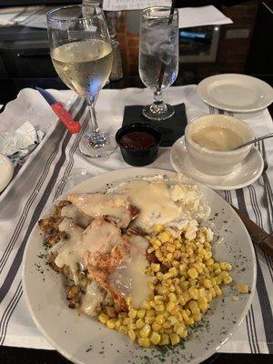 Baked chicken, mashed potatoes, corn, stuffing and gravy.  Chardonnay was great.