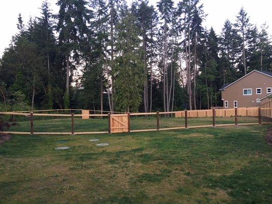 Dog Yard area facing larger yard. View fencing towards rear.