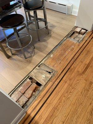 Existing opening before patching subfloor; new kitchen oak floor on left (not from A to Z), existing dining room floor on right.