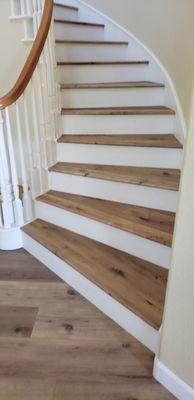 Vinyl plank on stairs with white risers.