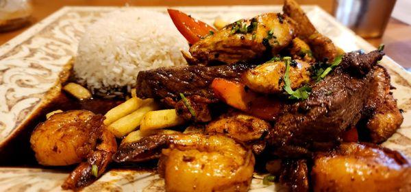 Tender chicken, flavorful steak, and amazing shrimp in a yummy sauce with French fries and rice.