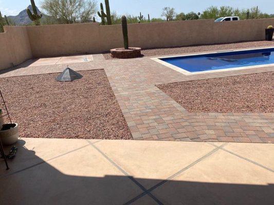 Pavers, gravel, cement patio, wall with stucco and circular planter