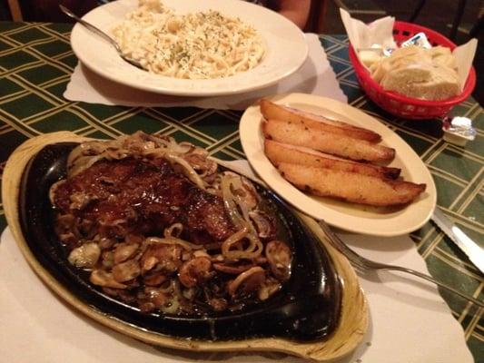 New York strip cooked medium and smothered with onions and mushrooms. The roasted garlic potatoes, and my wife's fettuccine.