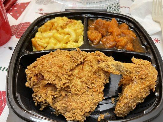 Fried chicken breast (with wing), with a side of Mac and cheese and yams.