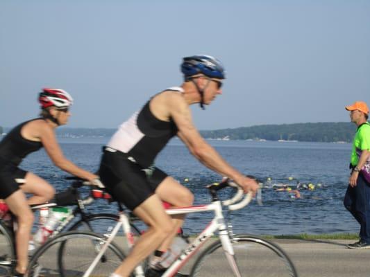 You can see swimmers in the lake and bikers riding beside them.