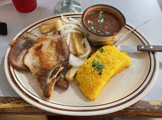 Pork chop, w fried yucca, rice, beans