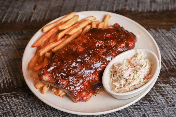 Babyback Ribs: slow roasted until they fall off the bone, brushed with BBQ sauce, served with fries and slaw. Half Rack 16.99