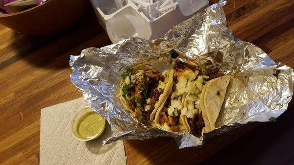 Carne asada, pollo and carnitas tacos to-go.  Green sauce was excellent.