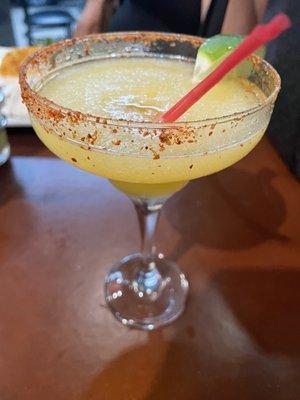 Frozen margarita with mango Tajín around the rim