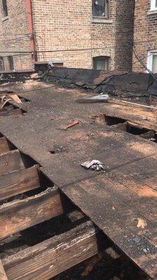 Tear off on flat roof. With your looking as is damaged wood that 80% of it needed to be replaced.