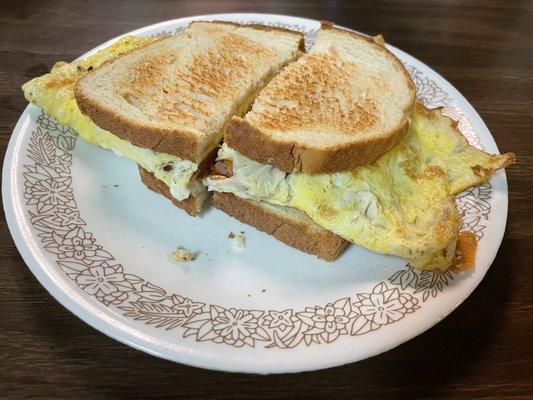 Breakfast sandwich with ham, eggs and cheese