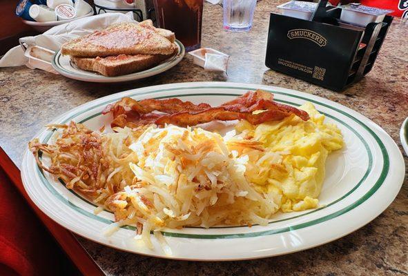 American scramble with has browns and bacon