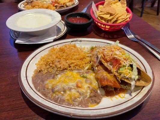 Shredded beef taco, chicken enchilada, queso blanco.