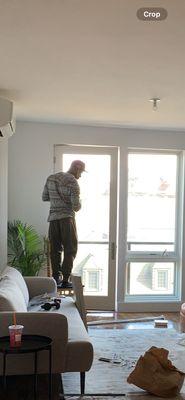 Maurice installing curtain rods for my mother's new apartment