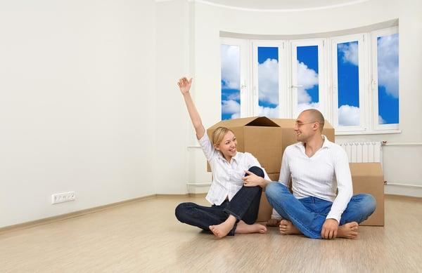 Young couple happy with there firsr place on new white Laminate