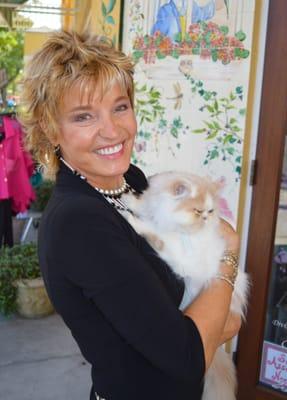 Wind In The Willows owner, Beth Ressler holding one of the store's persian kitty mascots, Lula Belle.